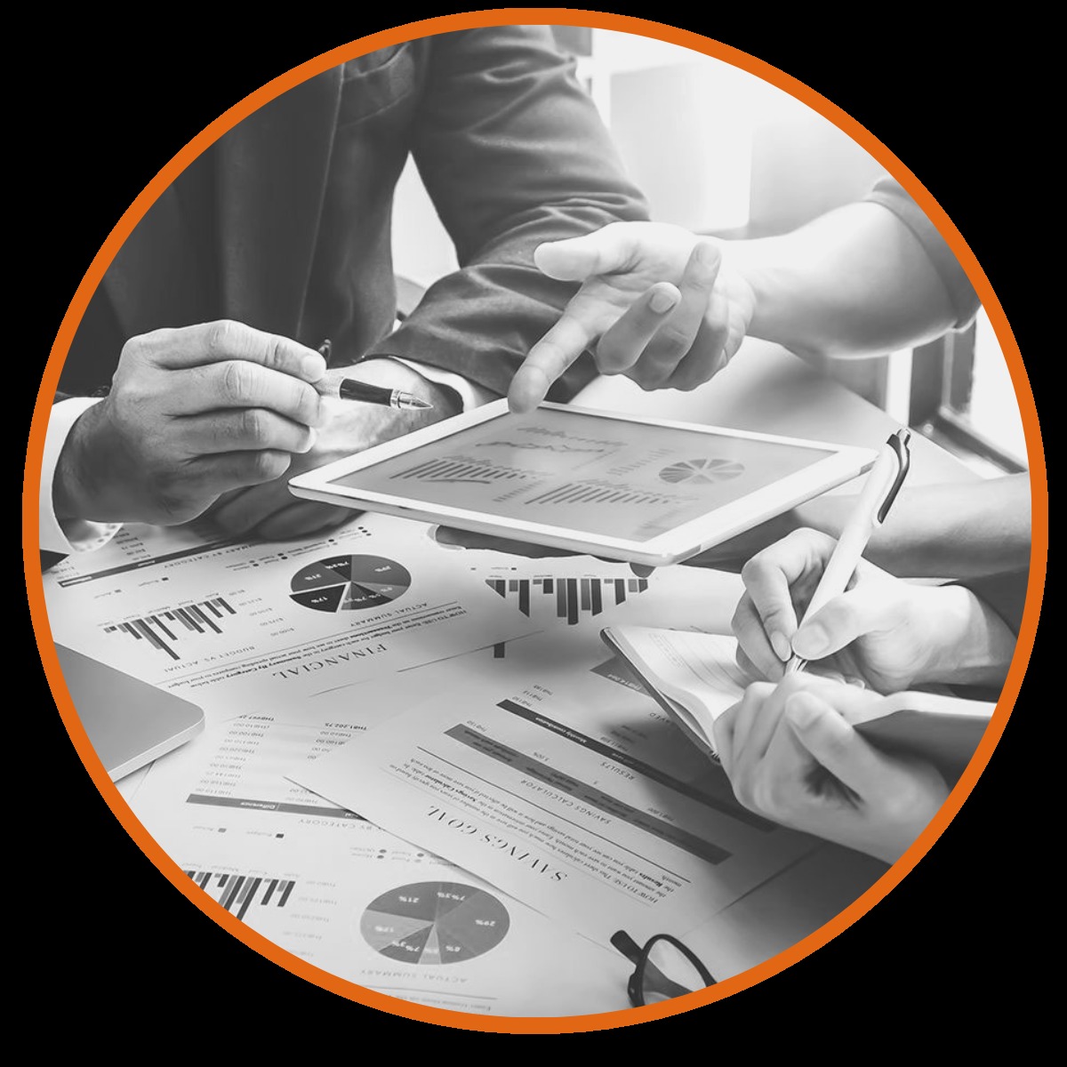 Two colleagues reviewing charts and documents at a table