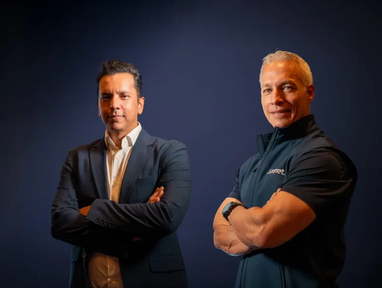 Two executives in a photograph published with CoreCard’s Euronet acquisition coverage