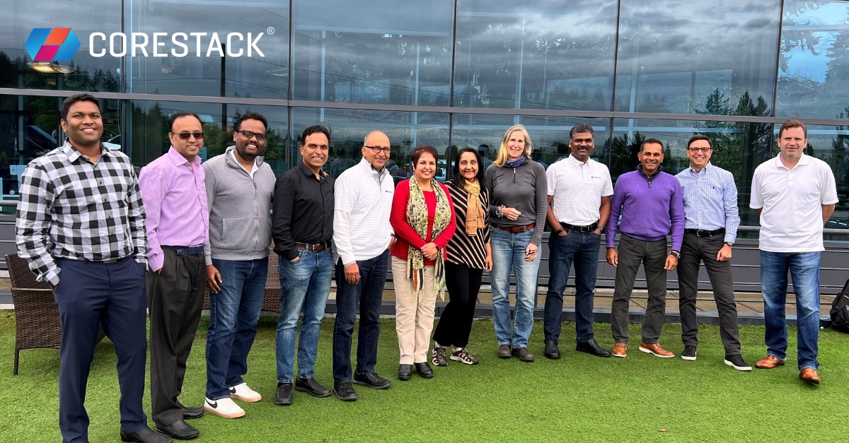 Twelve members of the CoreStack team standing together outside an office