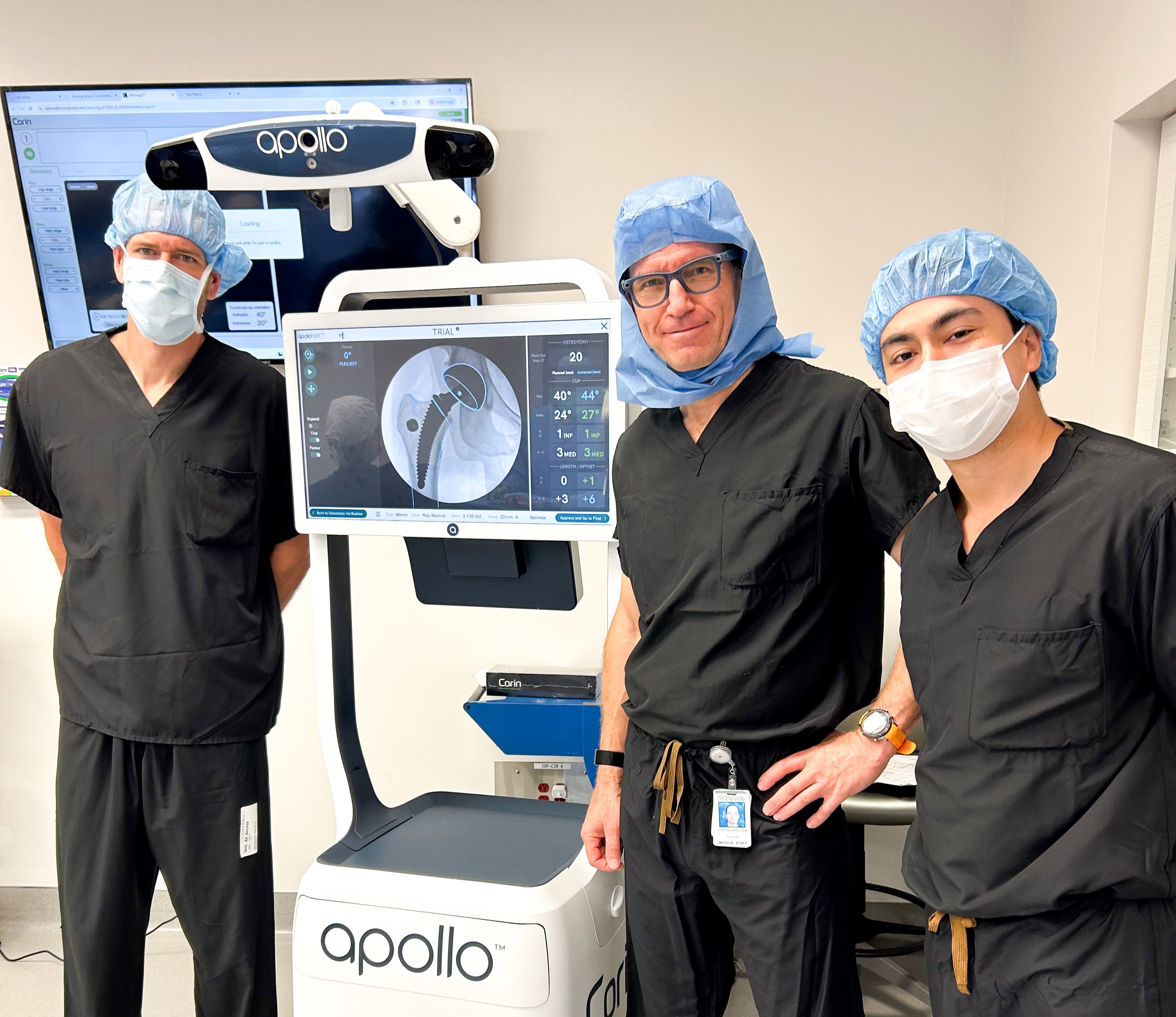 Dr Stefan Kreuzer and clinical colleagues beside an Apollo surgical station