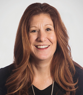 Corina Tracy in the company portrait accompanying her executive biography