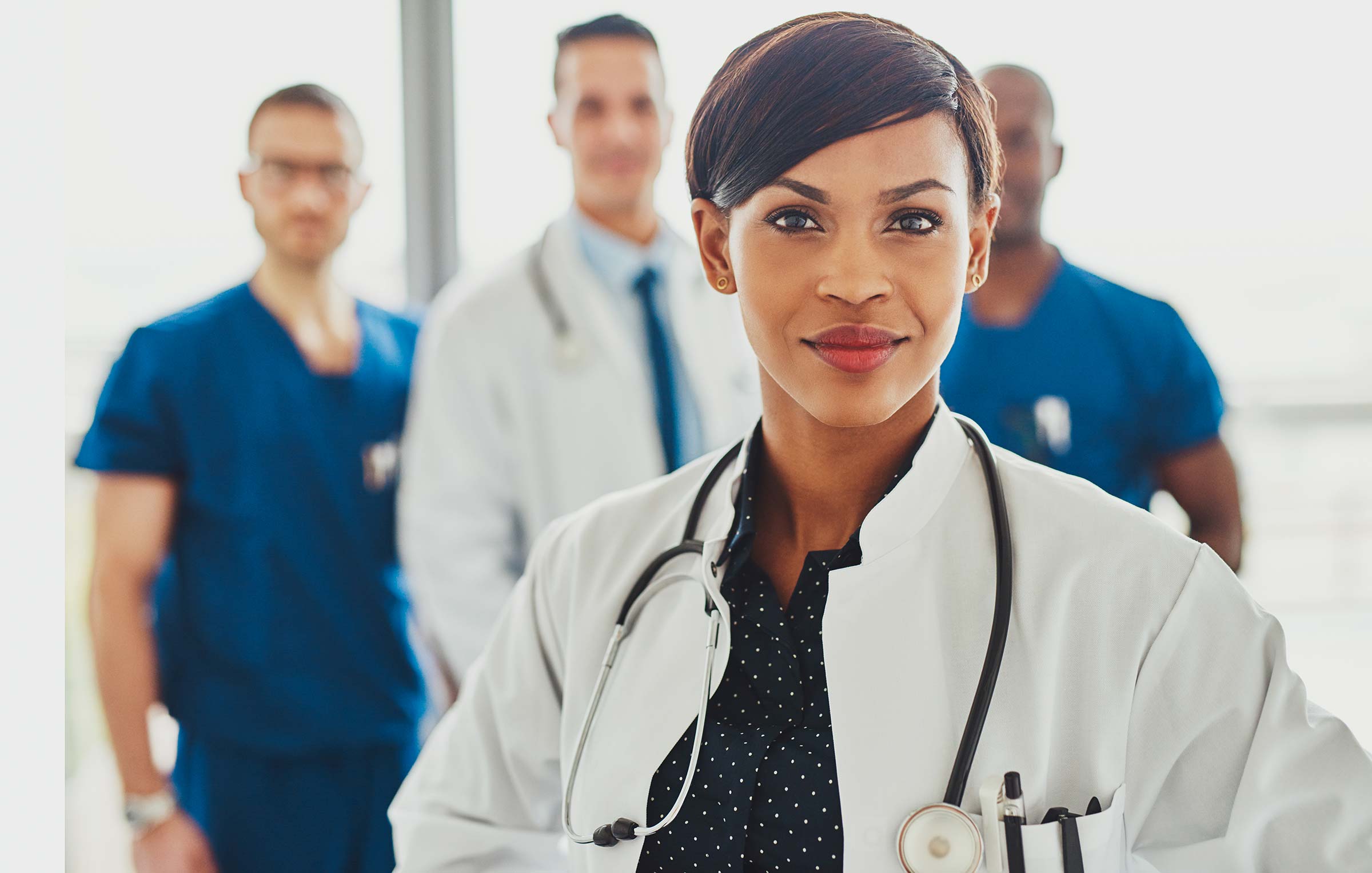A physician leading a medical team in discussion