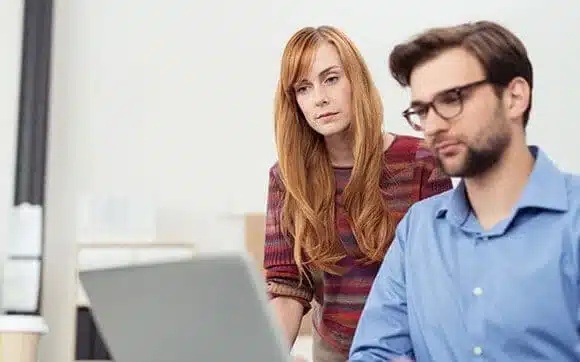 Two people reviewing a laptop in an image used on Corporate Technologies’ About page