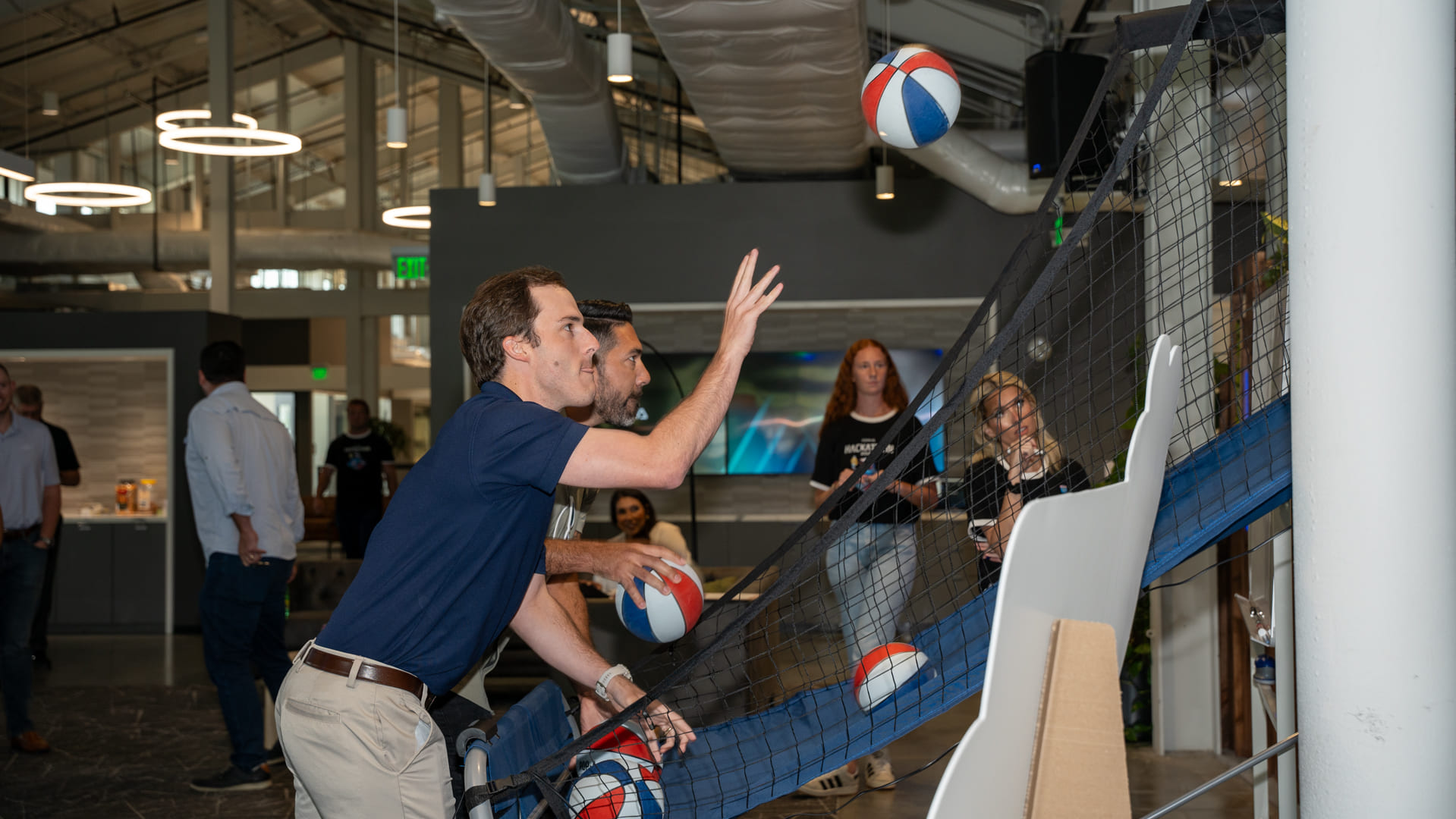 Corva colleagues playing an indoor basketball game at the company’s 2024 hackathon