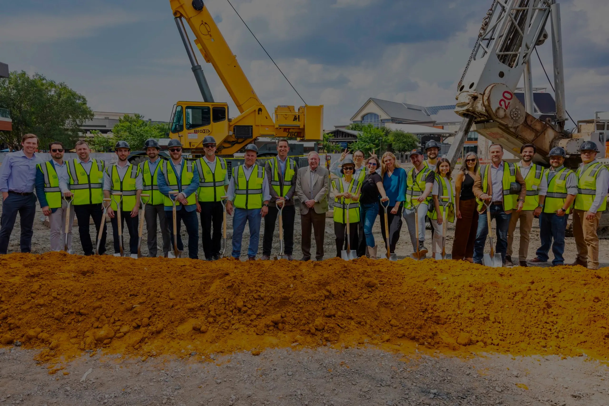 Cosm team and partners with shovels and safety vests at the Dallas venue groundbreaking