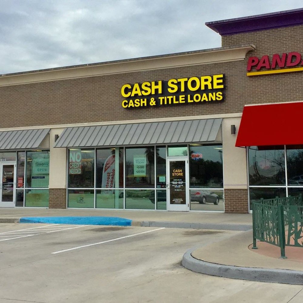 Historical Cash Store branch with yellow lettering and cash and title loan advertisements