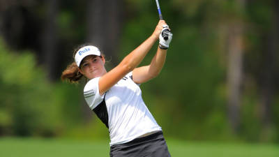 Courtney Ellenbogen following through on a golf swing in her Duke uniform