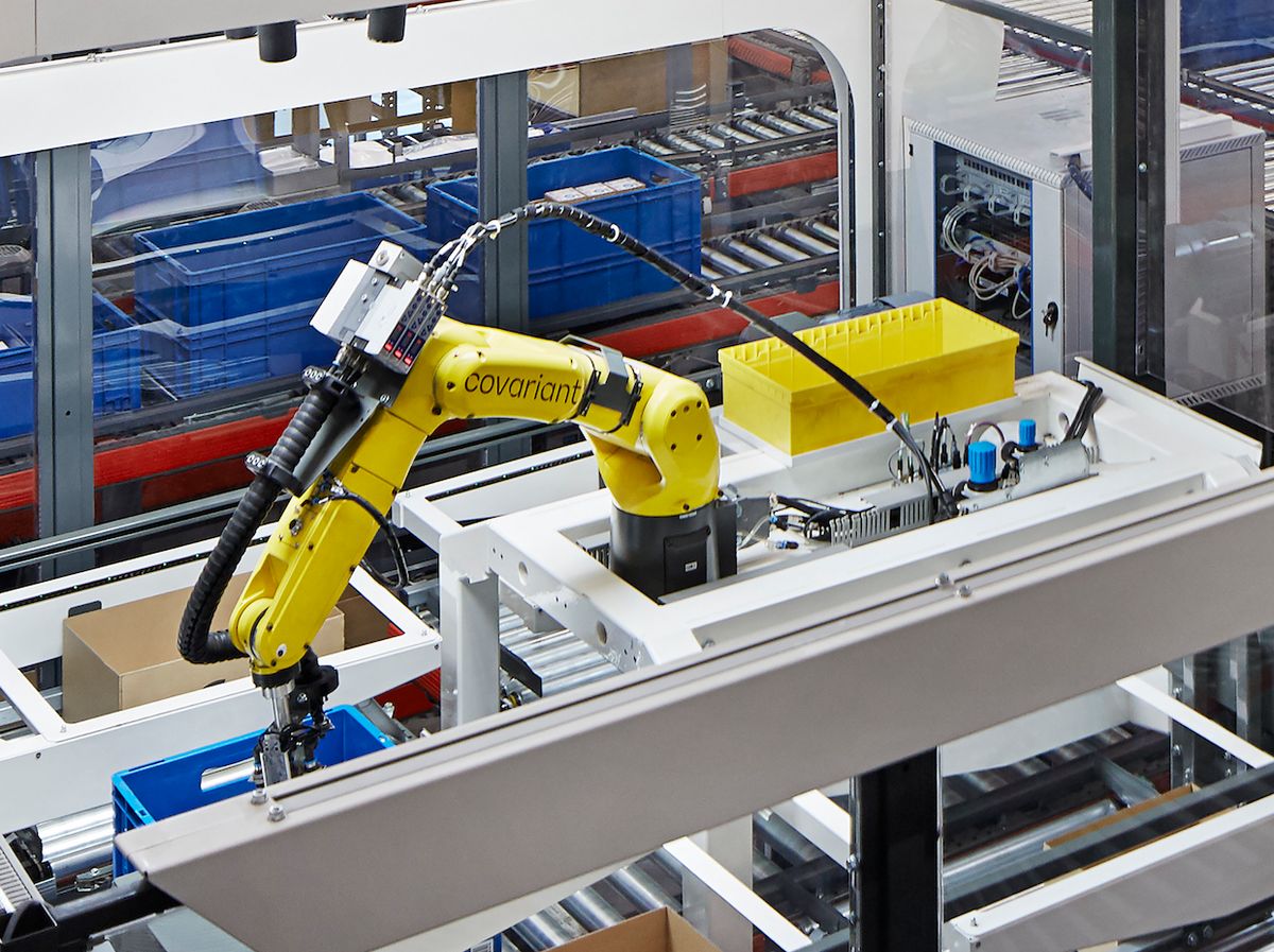 A Covariant-powered robot arm picking products from a tote in a KNAPP warehouse near Berlin
