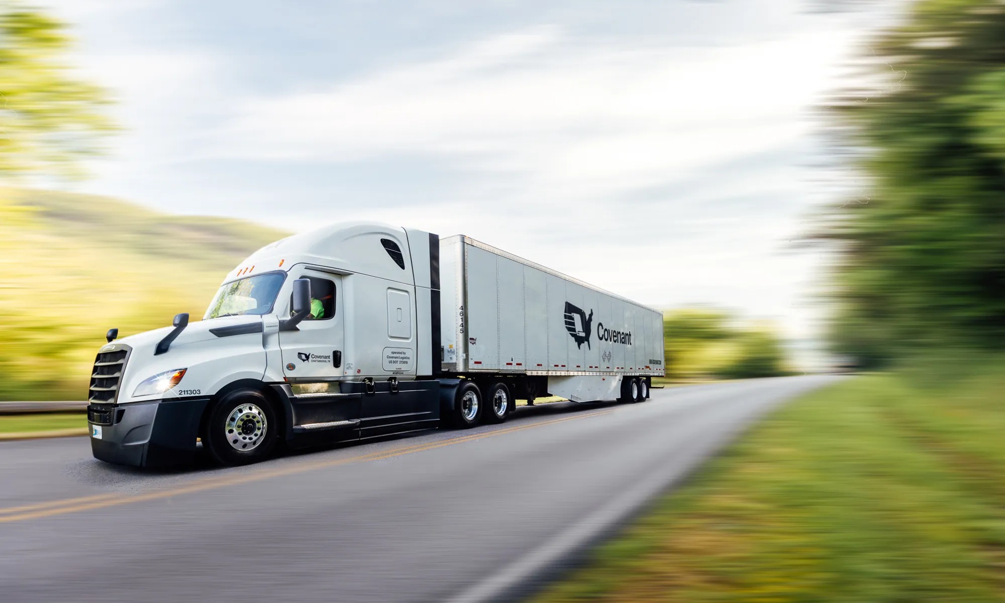 A Covenant tractor-trailer traveling along a highway