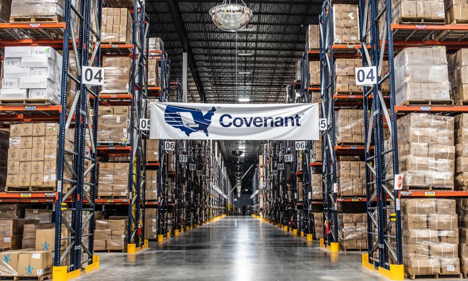 Tall warehouse racks holding palletized goods along a Covenant distribution center aisle