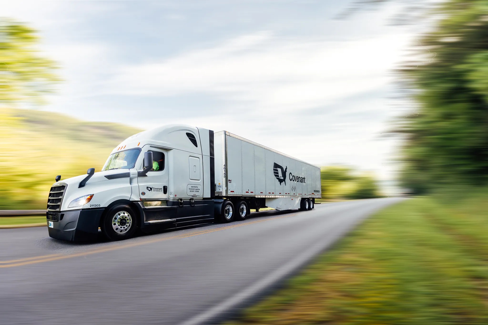 A Covenant tractor-trailer traveling along a highway