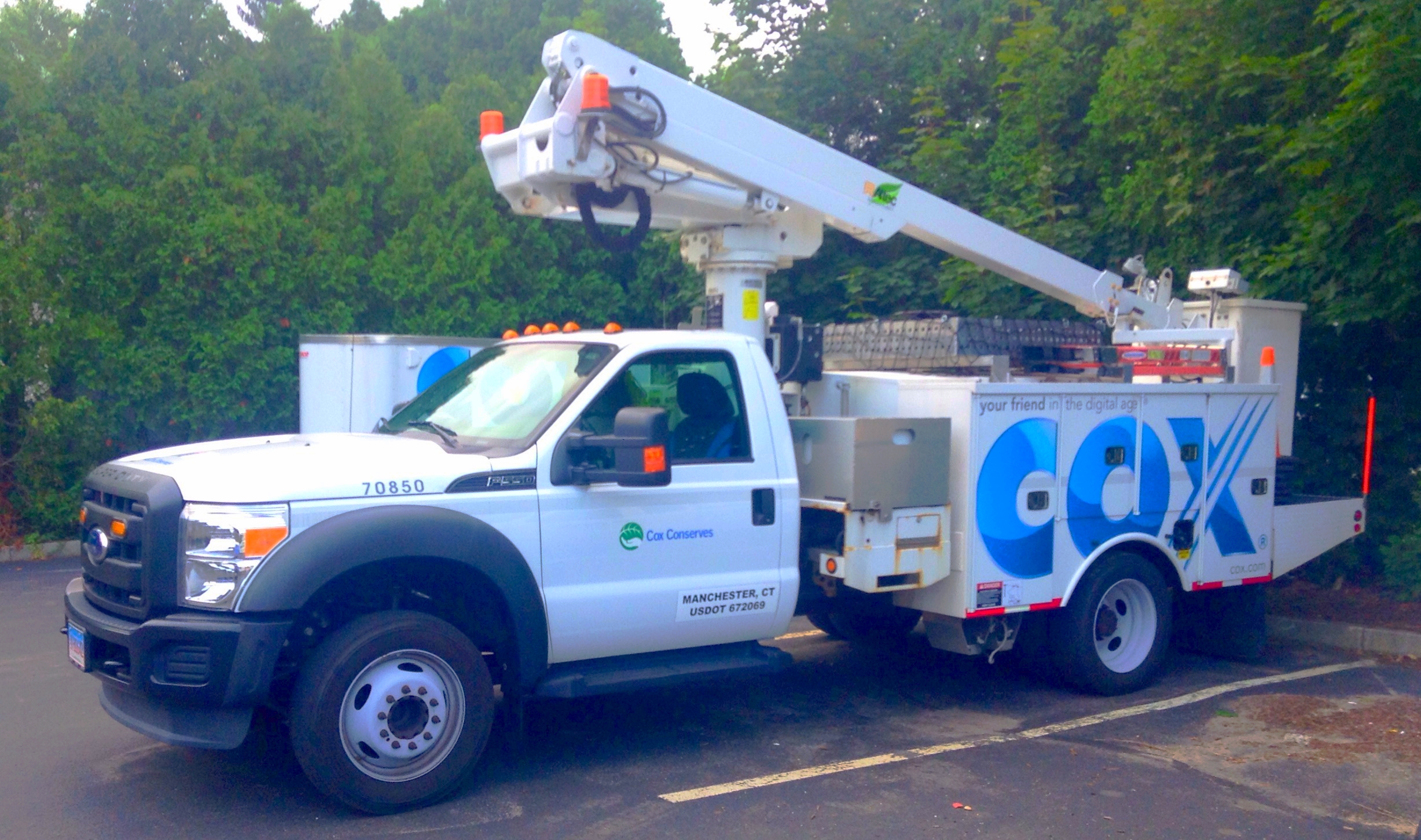 A Cox Cable service truck parked on a street