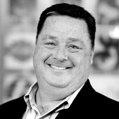 Black-and-white portrait of Coyne PR founder Tom Coyne