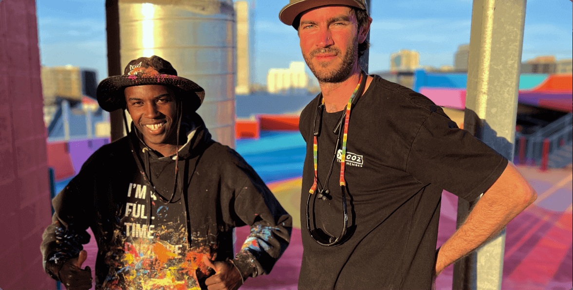 A COZ team member and another participant at the colorful DENVER WALLS installation