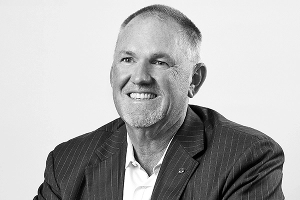 Craig Kliethermes smiling in a candid black-and-white RLI executive photograph