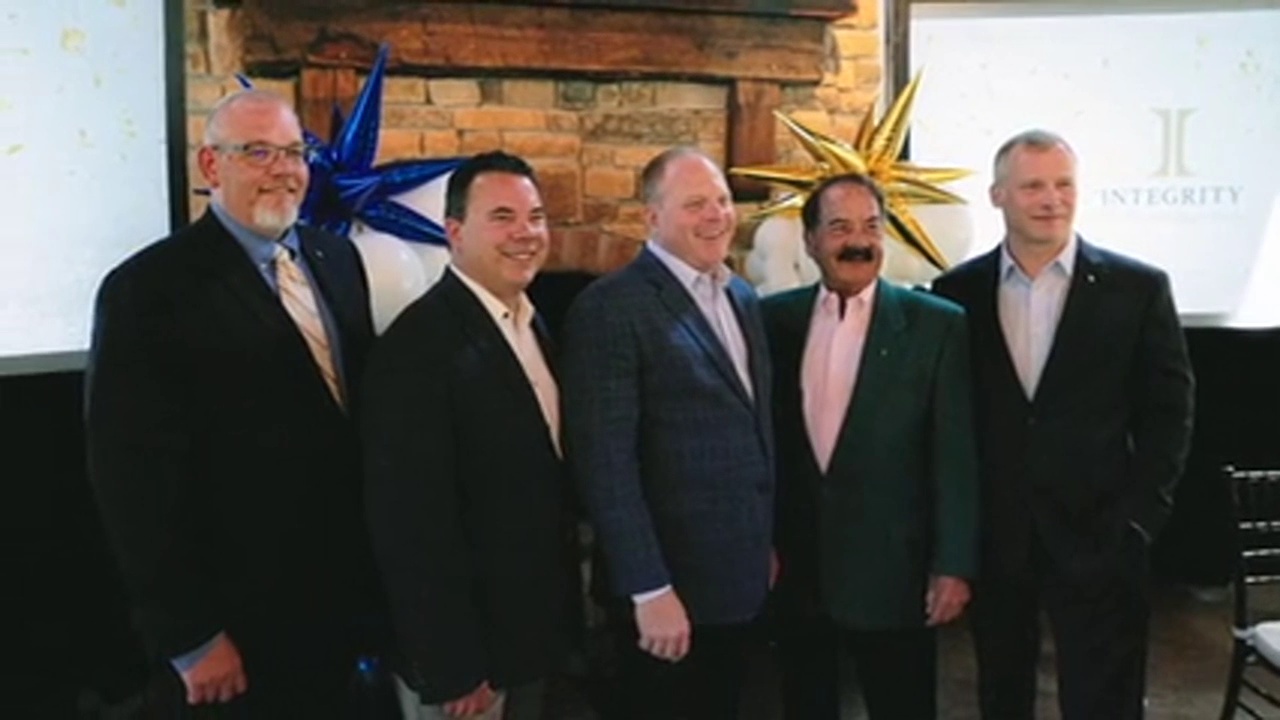 Craig Ritter, second from left, smiling with four colleagues in the 2022 Ritter and Integrity partnership announcement film