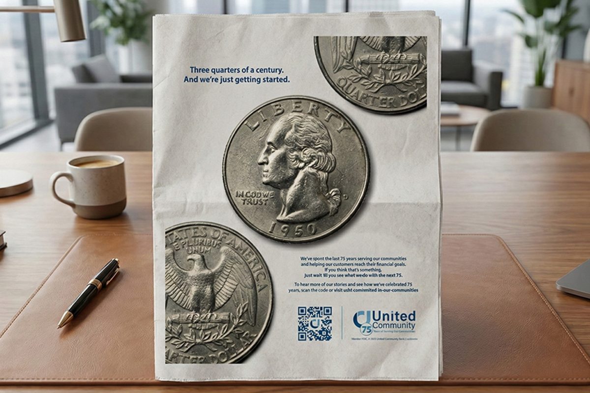 United Community anniversary newspaper advertisement created by Crawford, standing on an office desk