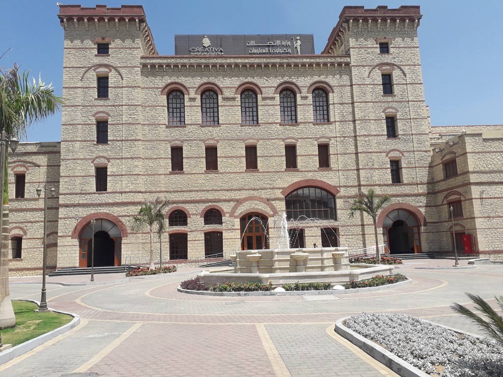 CREATIVA’s Cairo University location with stone facade, twin towers and courtyard fountain