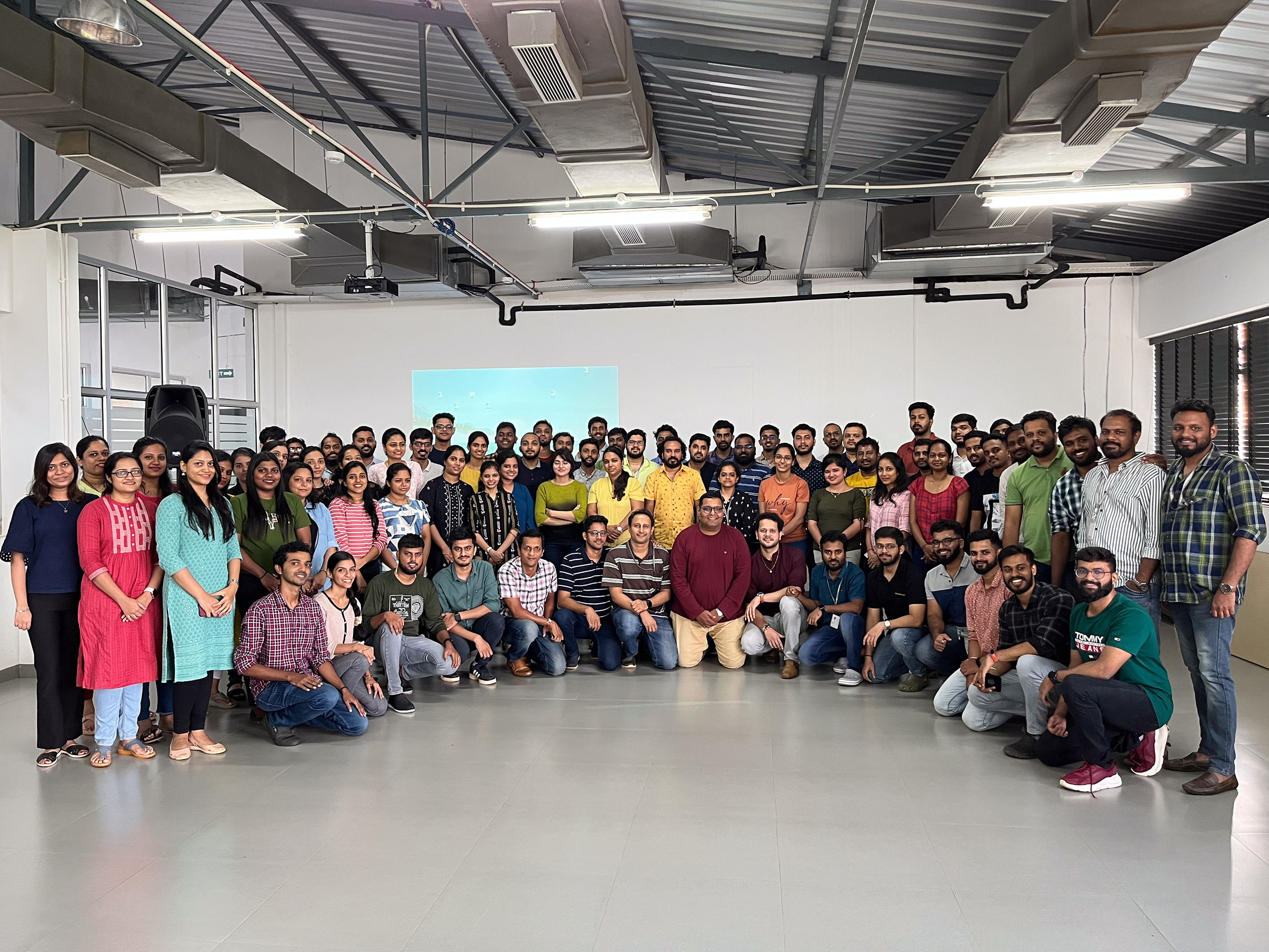 Creative Capsule team members gathered for a group photograph in an office