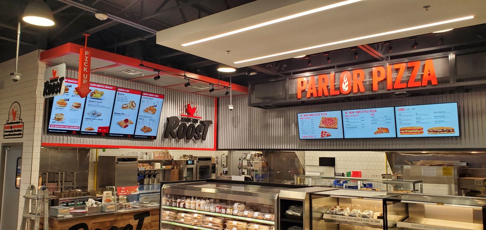 Roost and Parlor Pizza food counters with digital menu boards in a 7-Eleven location