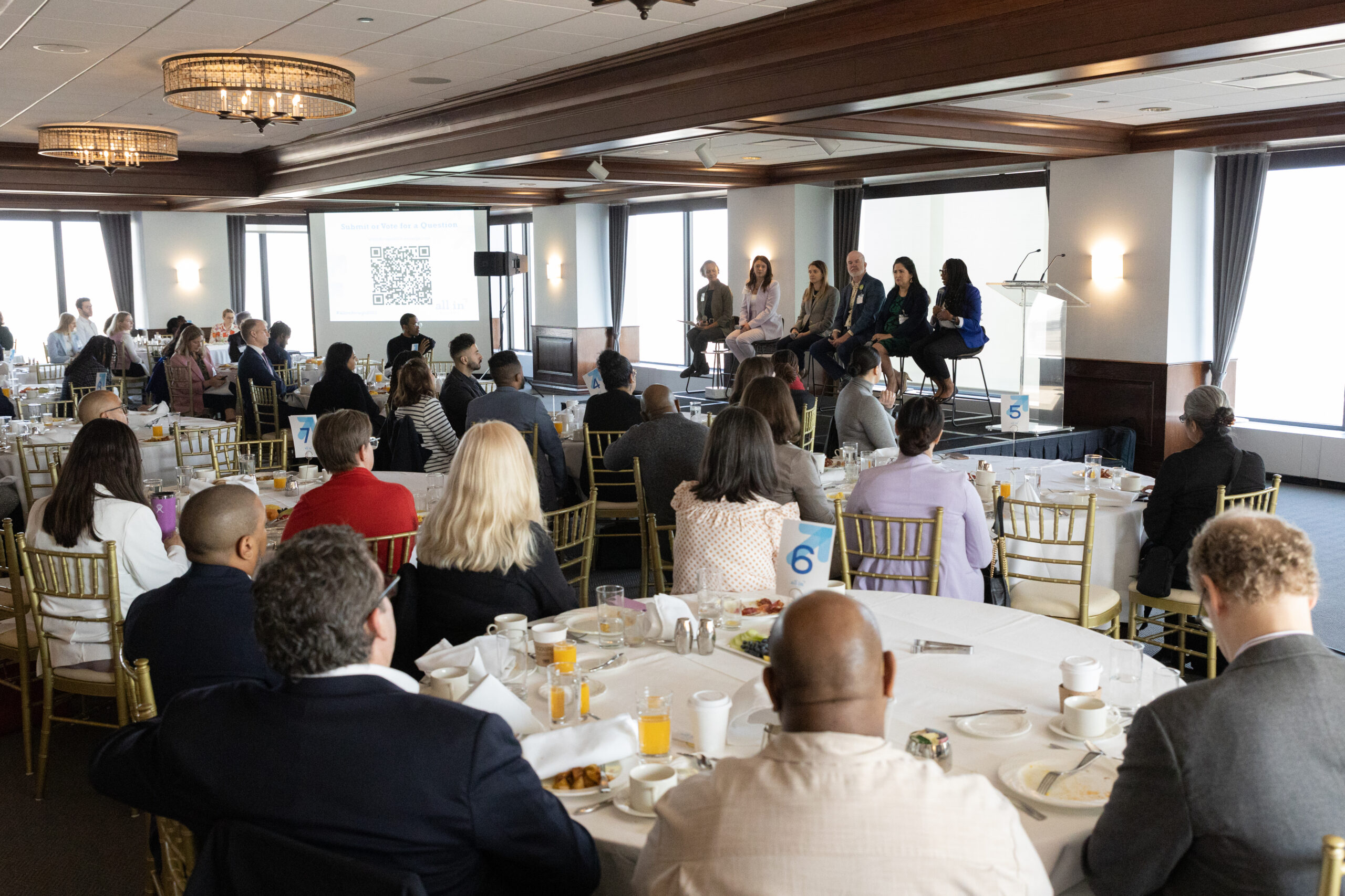 Cristal Gary, at the right of the panel, participates in a six-person discussion at The Metropolitan in Chicago.