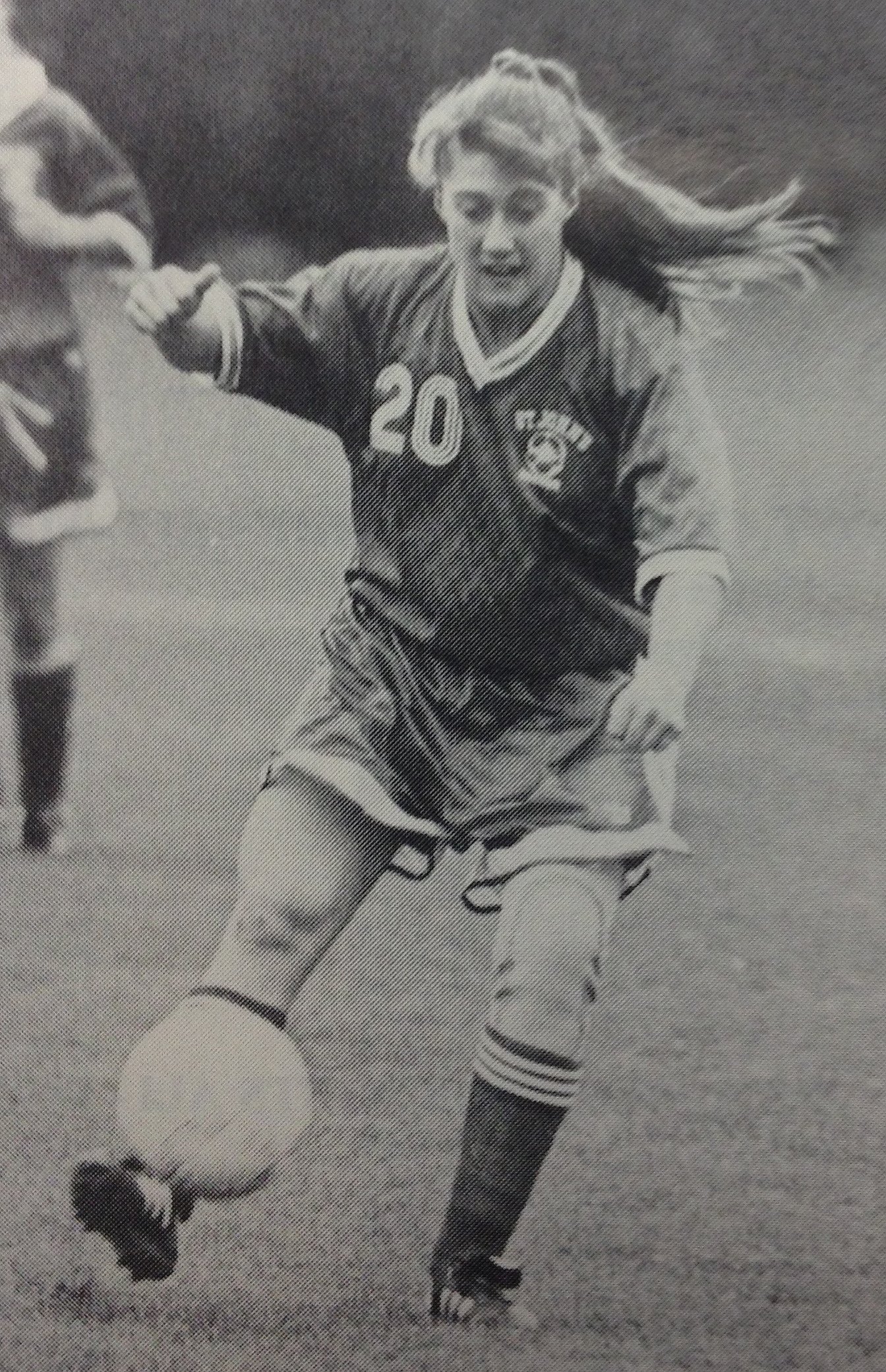 Archival photograph of Cristin Burtis playing soccer for St. John’s in the number 20 jersey