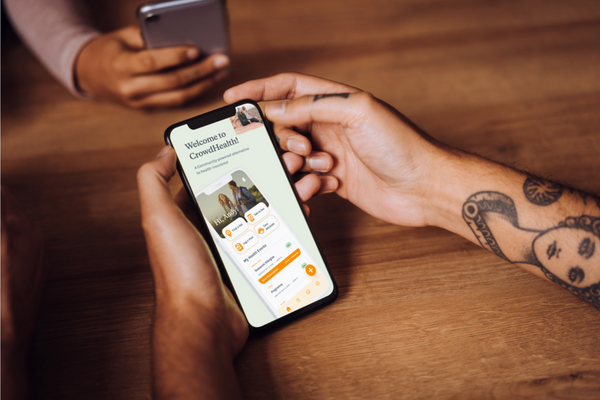 Company photograph of the CrowdHealth app displayed on a smartphone