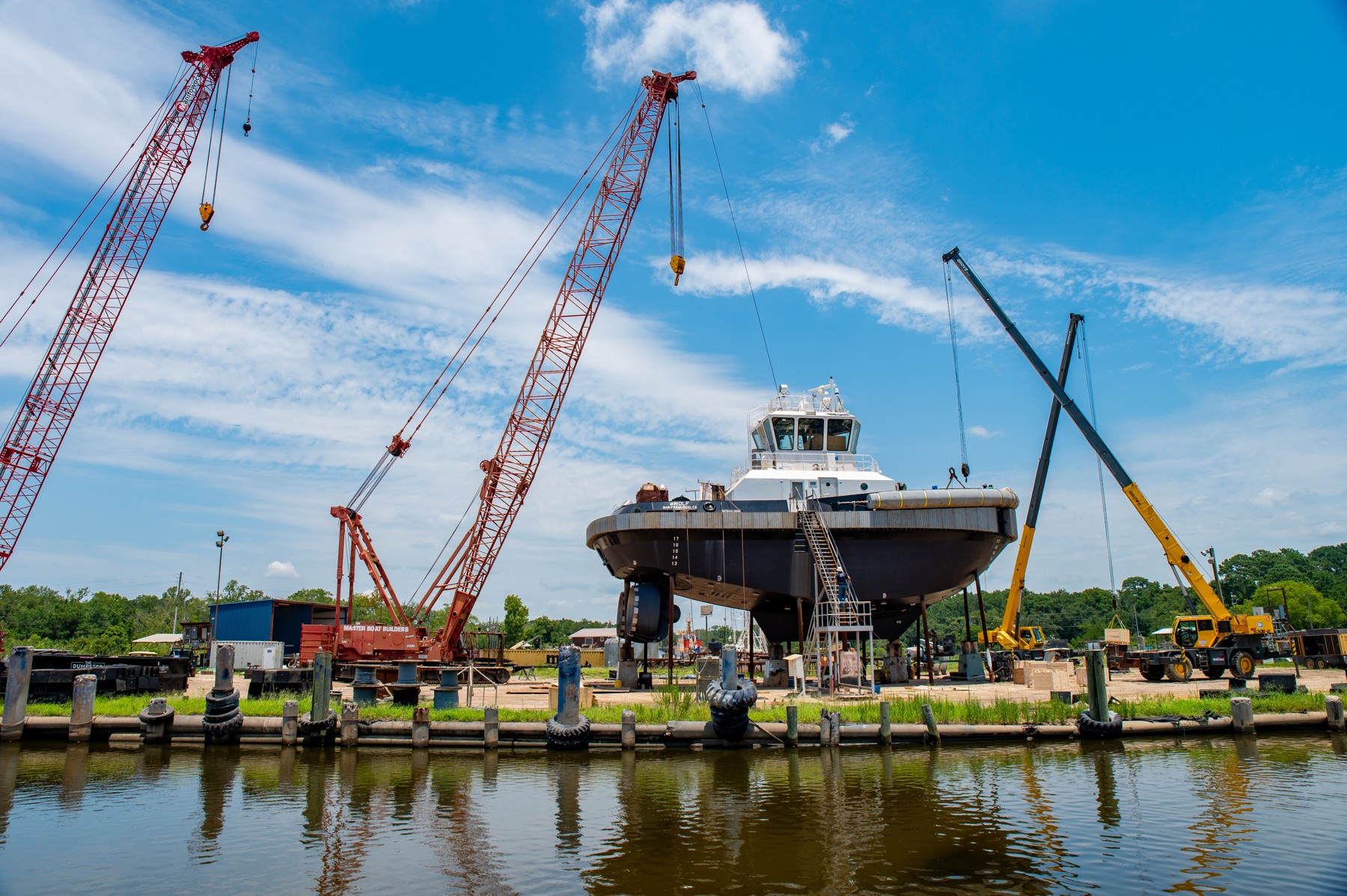 eWolf standing on supports at a shipyard, with cranes around the vessel.
