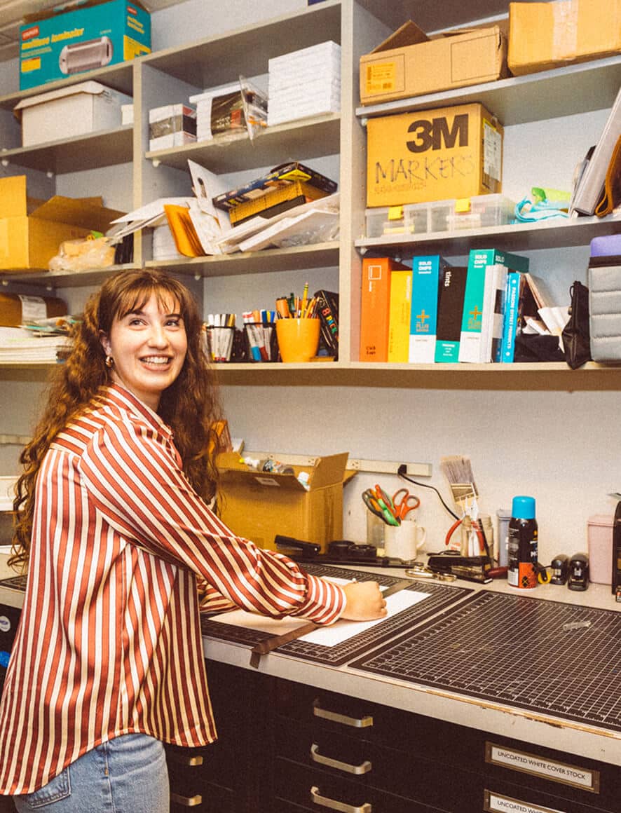 A Crowley Webb team member working at a production table in the agency office