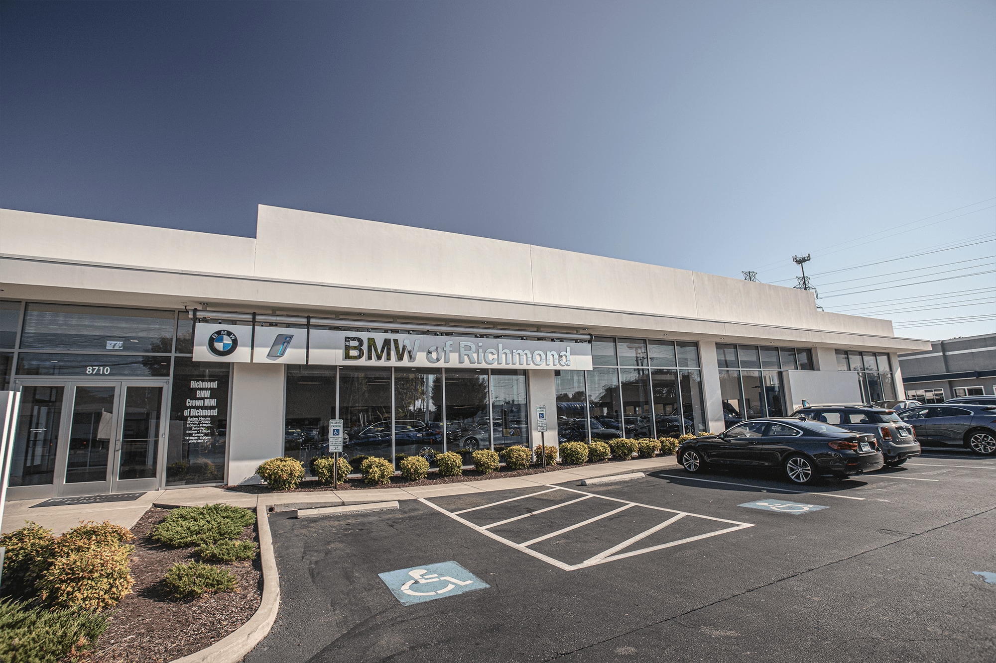 The BMW of Richmond showroom entrance with parked cars and glass windows