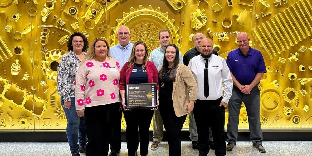 CRST’s Caterpillar team posing with its Supplier Excellence recognition plaque