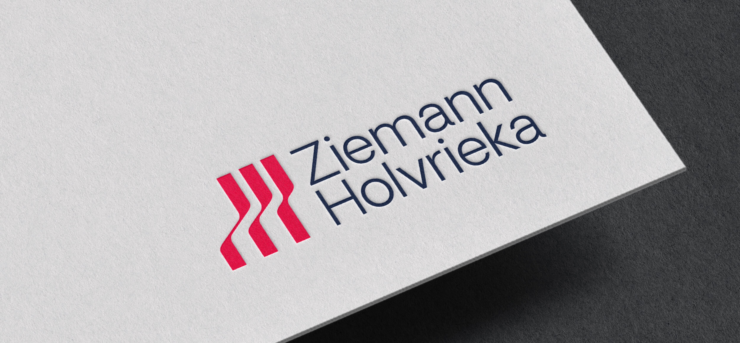 CRUSH’s red vessel-inspired symbol and navy wordmark for Ziemann Holvrieka on a print mockup