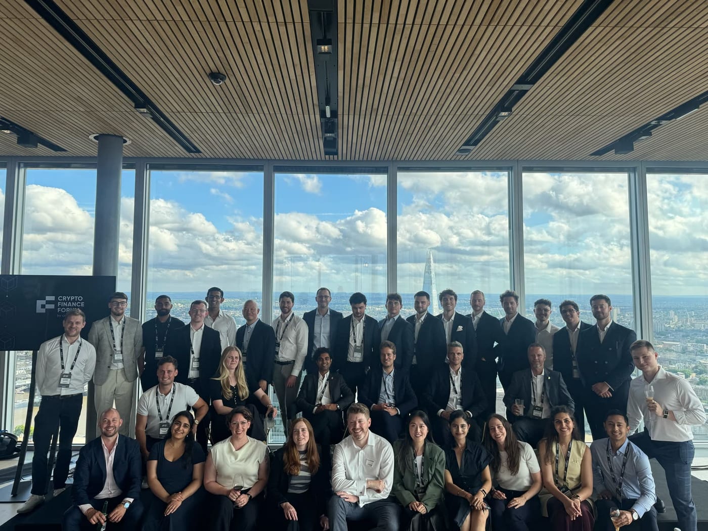 Cryptio team gathered at Crypto Finance Forum beside large windows overlooking London