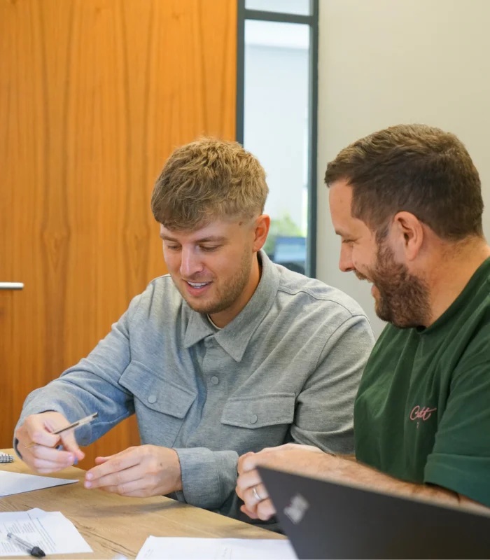 Two CSG colleagues reviewing work together at a table