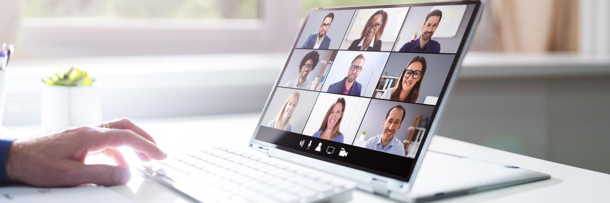 A laptop showing a grid of people in a virtual meeting