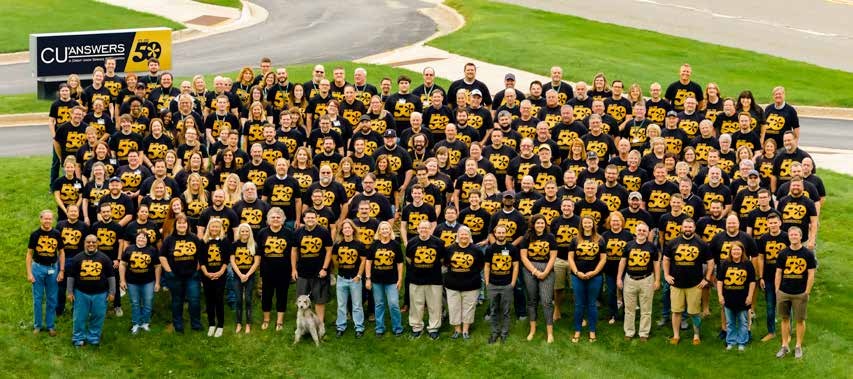 CU*Answers employees gathered outside in matching black shirts for the company’s 50th anniversary