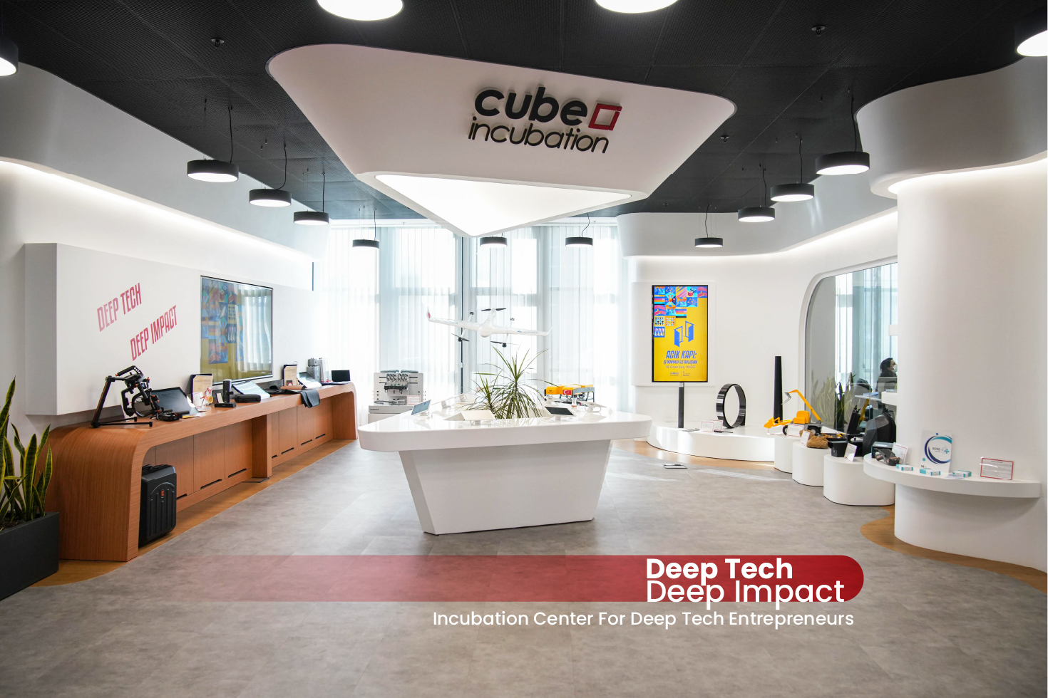 Cube Incubation showroom with technology displays arranged around a central exhibit table