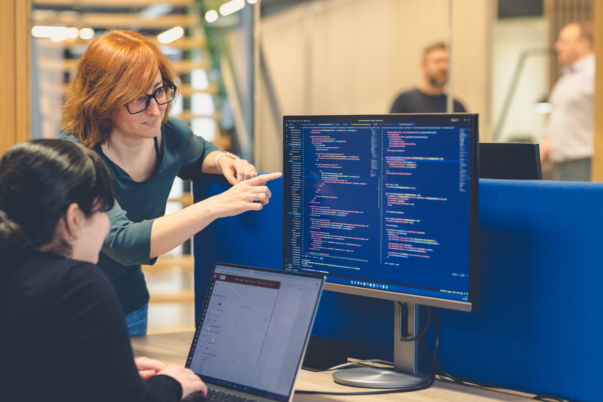 Cubigo team members collaborating around a computer screen