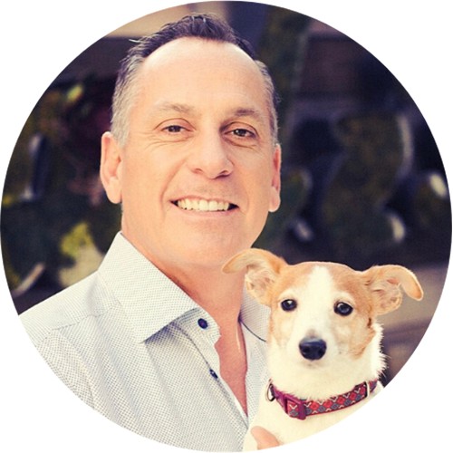 John Hussey, founder and CEO of CUDDLY, holding a small dog