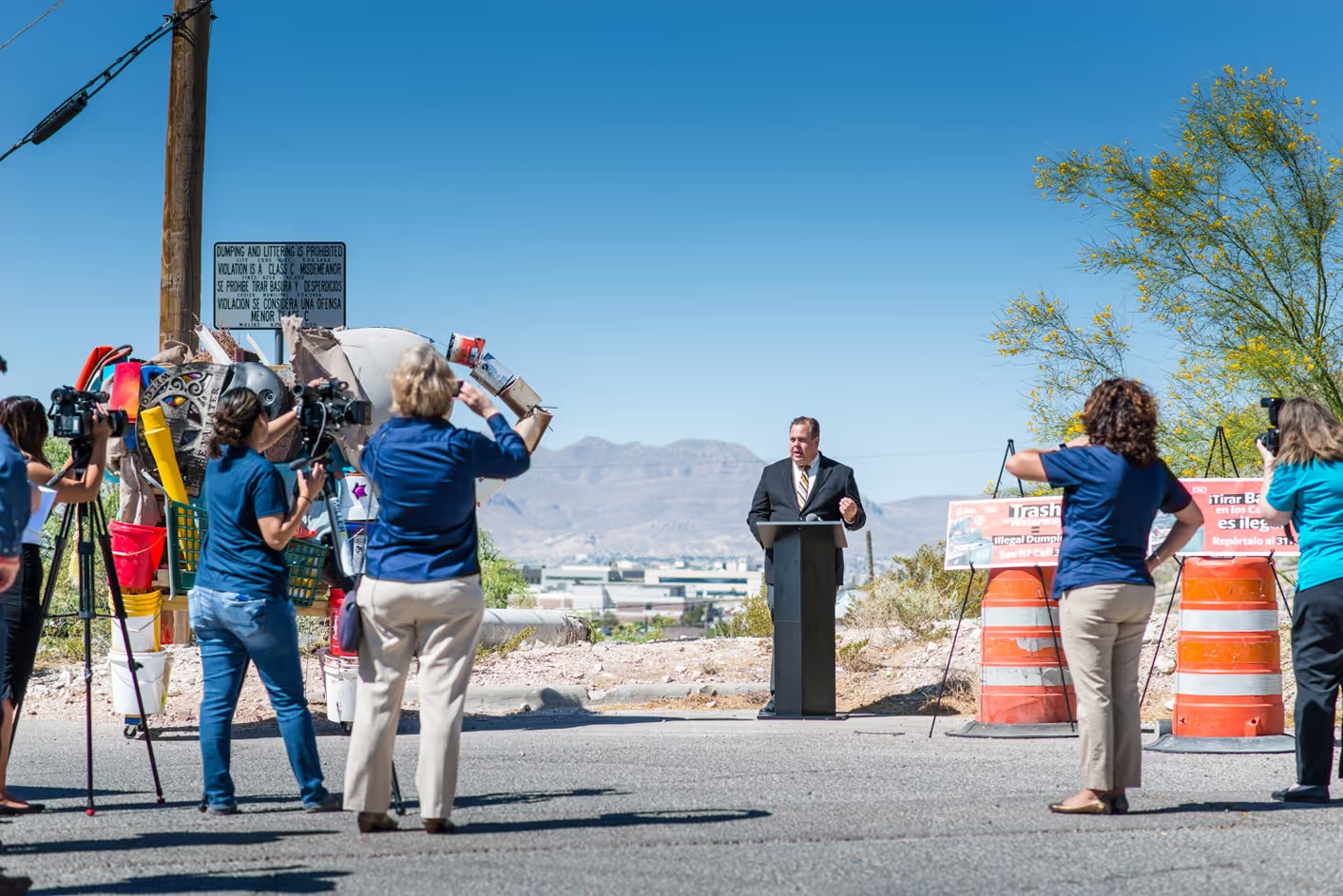 Media gather around an elephant sculpture made from discarded material at an El Paso Water campaign event
