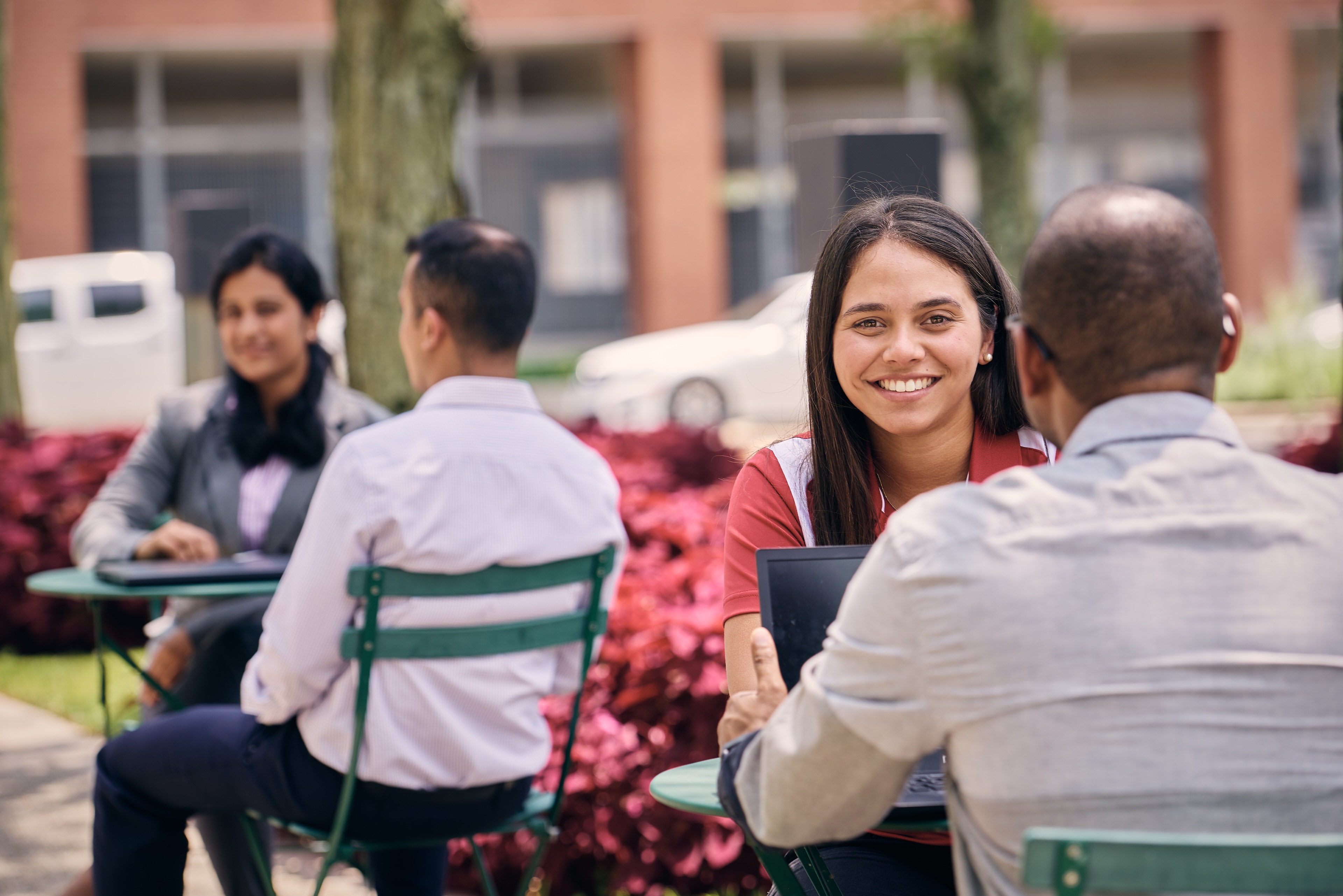 Cummins employees gathered around an outdoor table