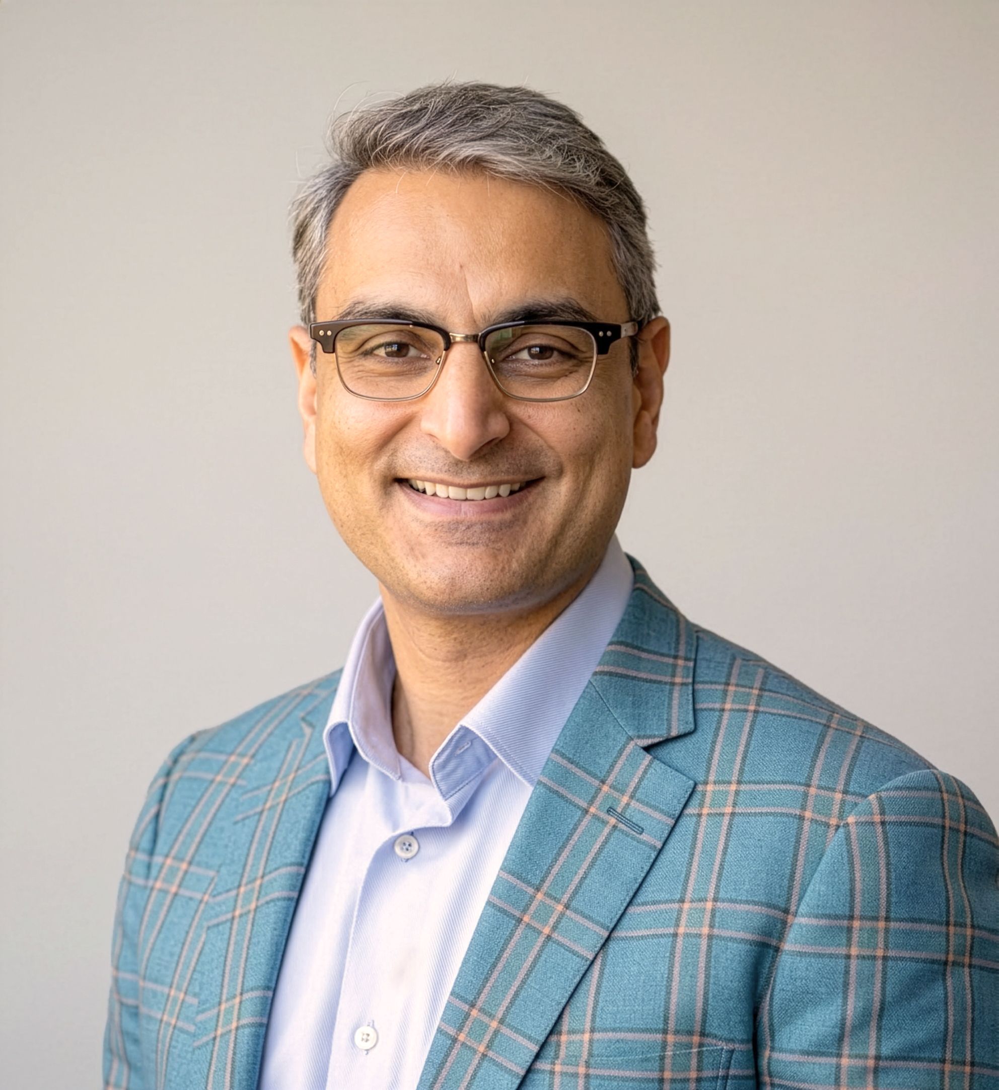 Curinos CEO Sid Singh in a blue checked jacket