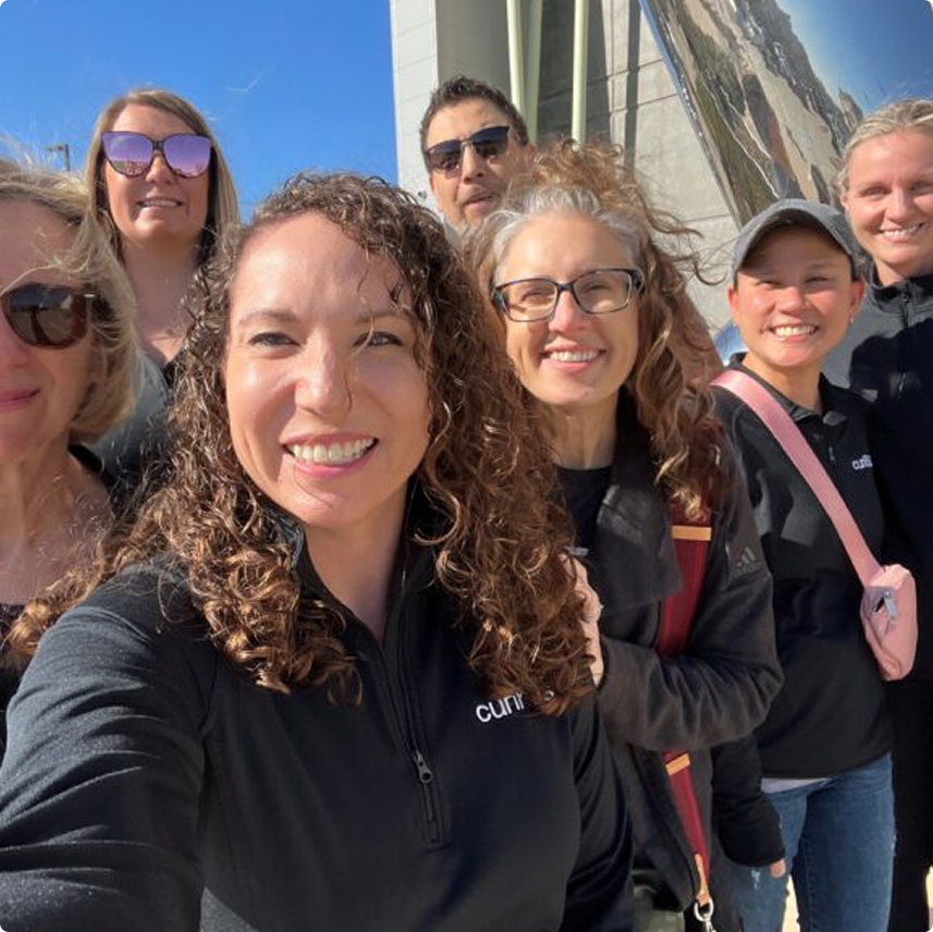 Curinos colleagues together outdoors in a team photograph