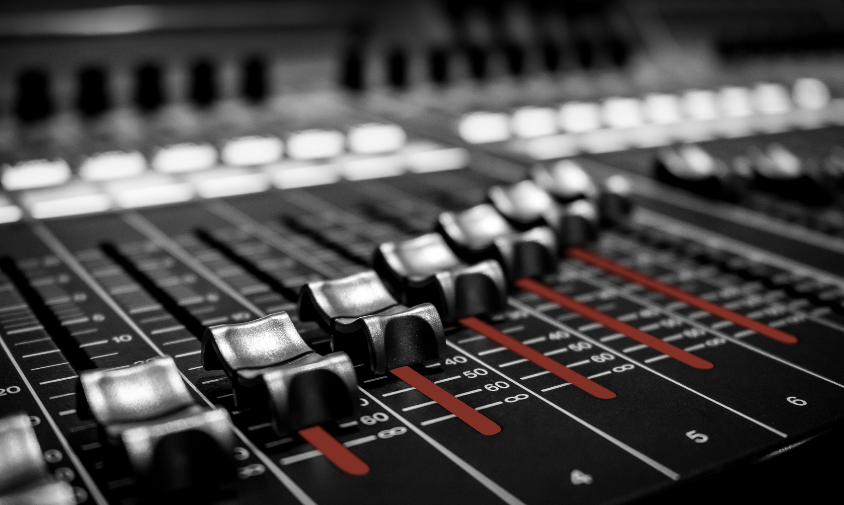 Close view of faders on an audio mixing console