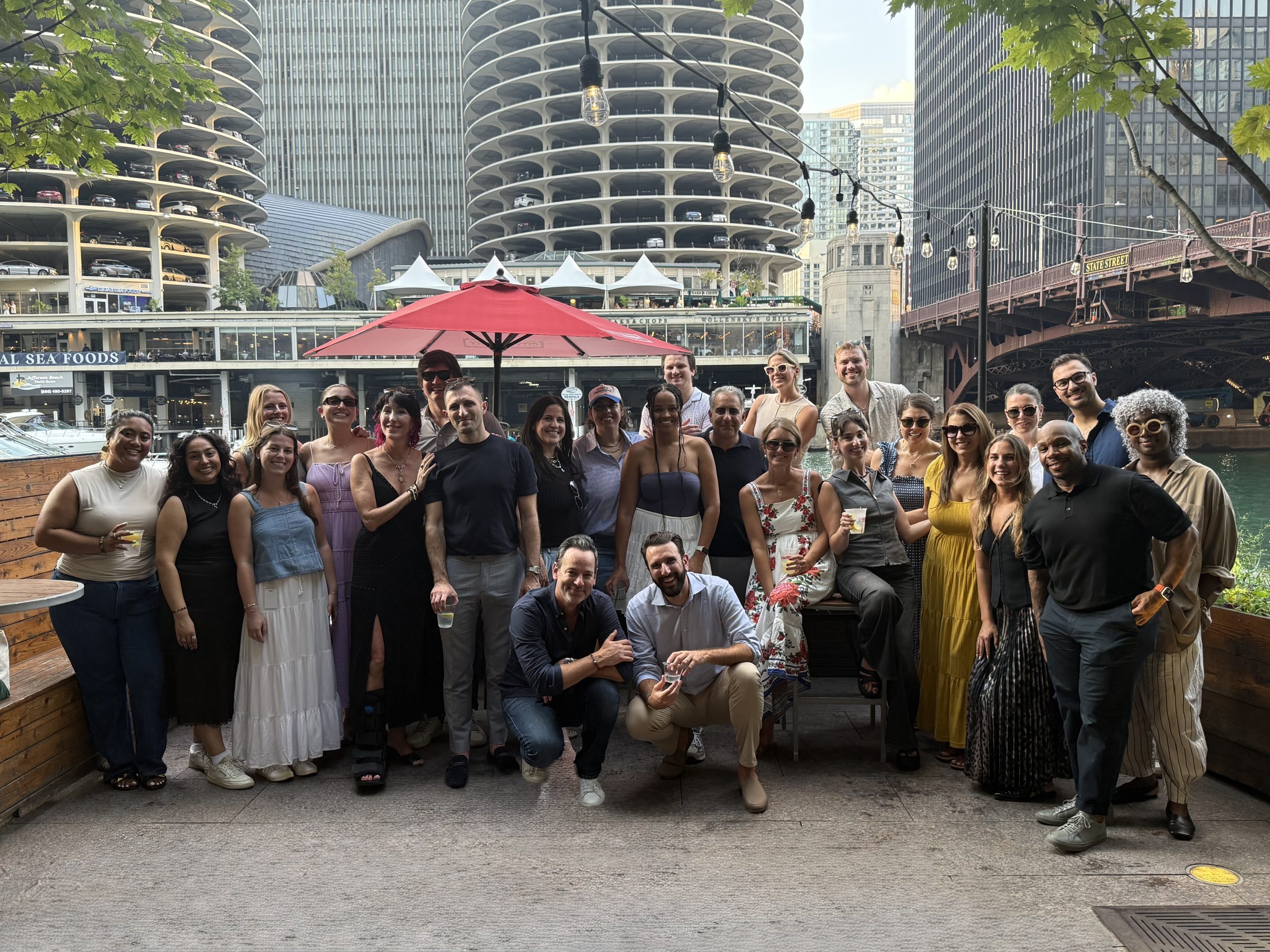 Current Global Chicago team gathered outdoors during a summer outing
