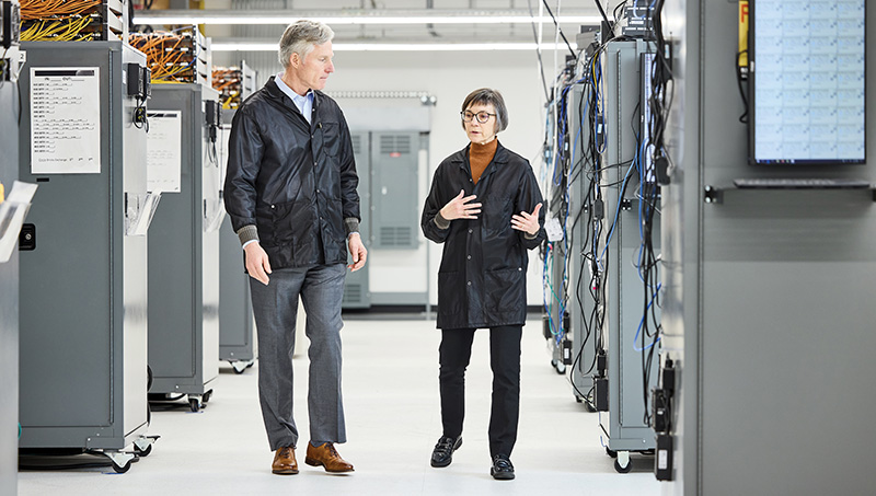 Two Curtiss-Wright employees discussing equipment in the Portland facility