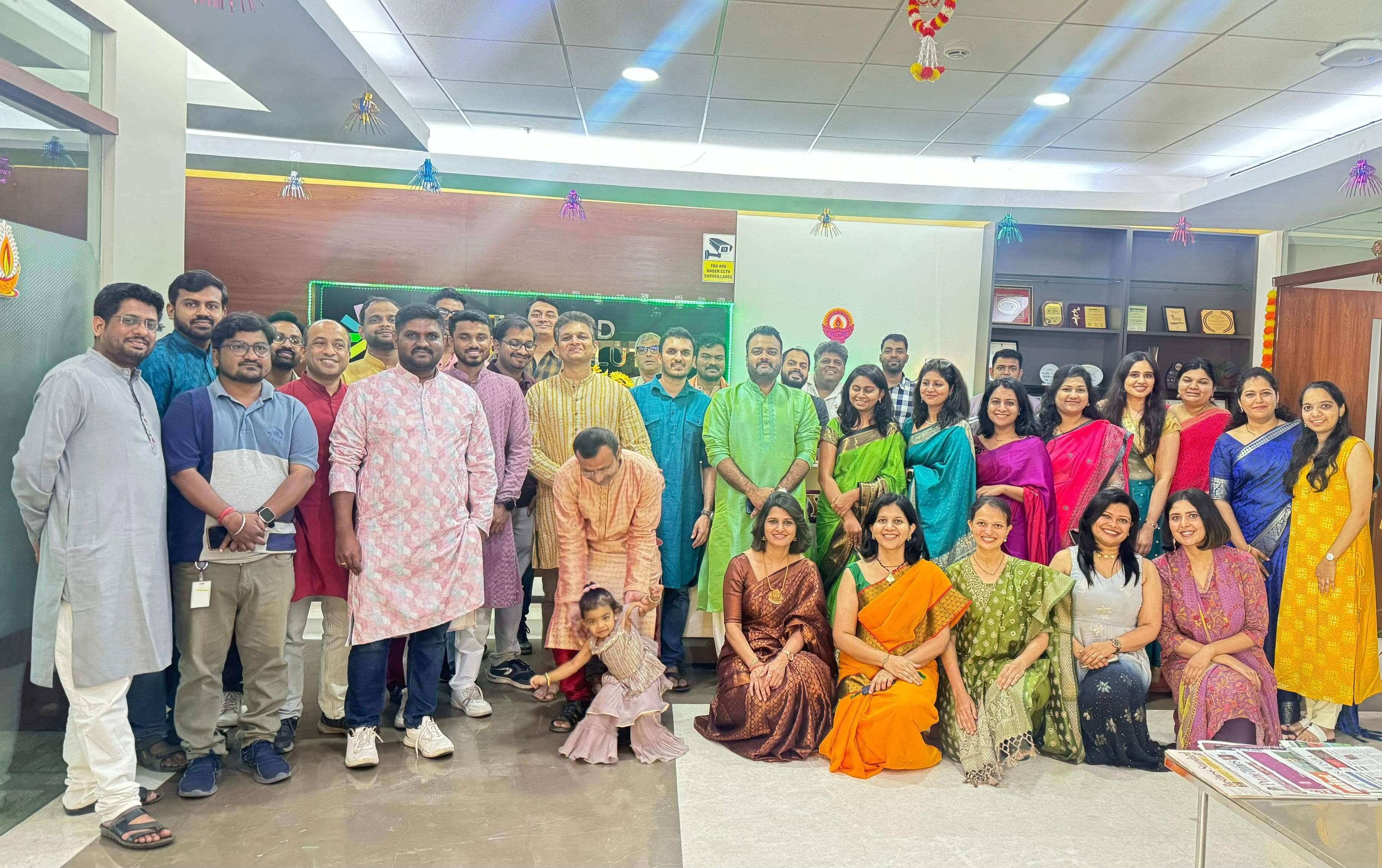CES colleagues gathered together in an office, wearing colorful clothes