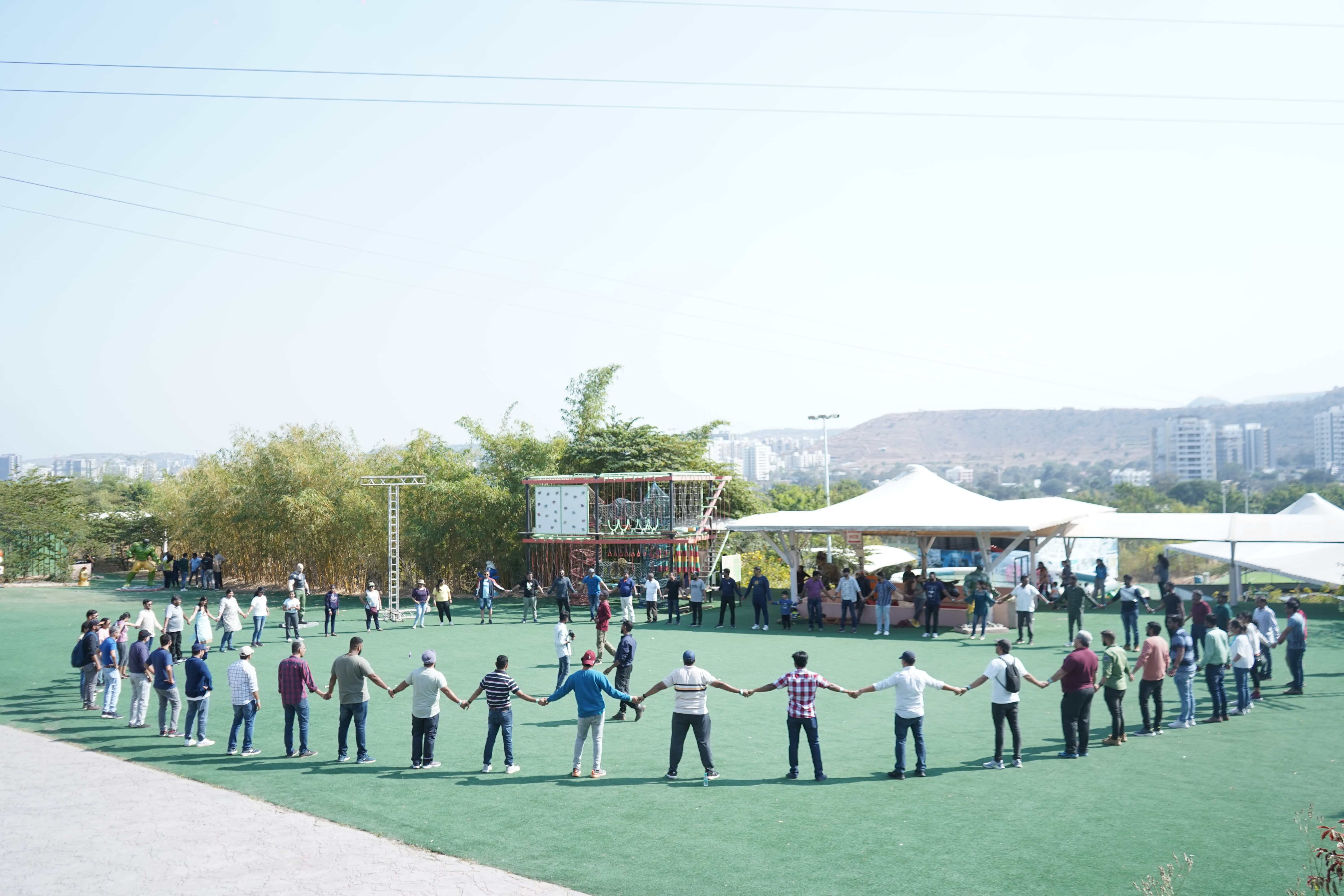 A large group from CES’s careers gallery standing in a circle outdoors