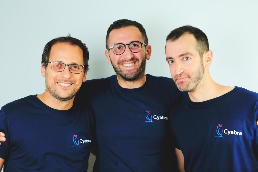 Cyabra co-founders Dan Brahmy, Yossef Daar and Ido Shraga standing together in navy Cyabra shirts