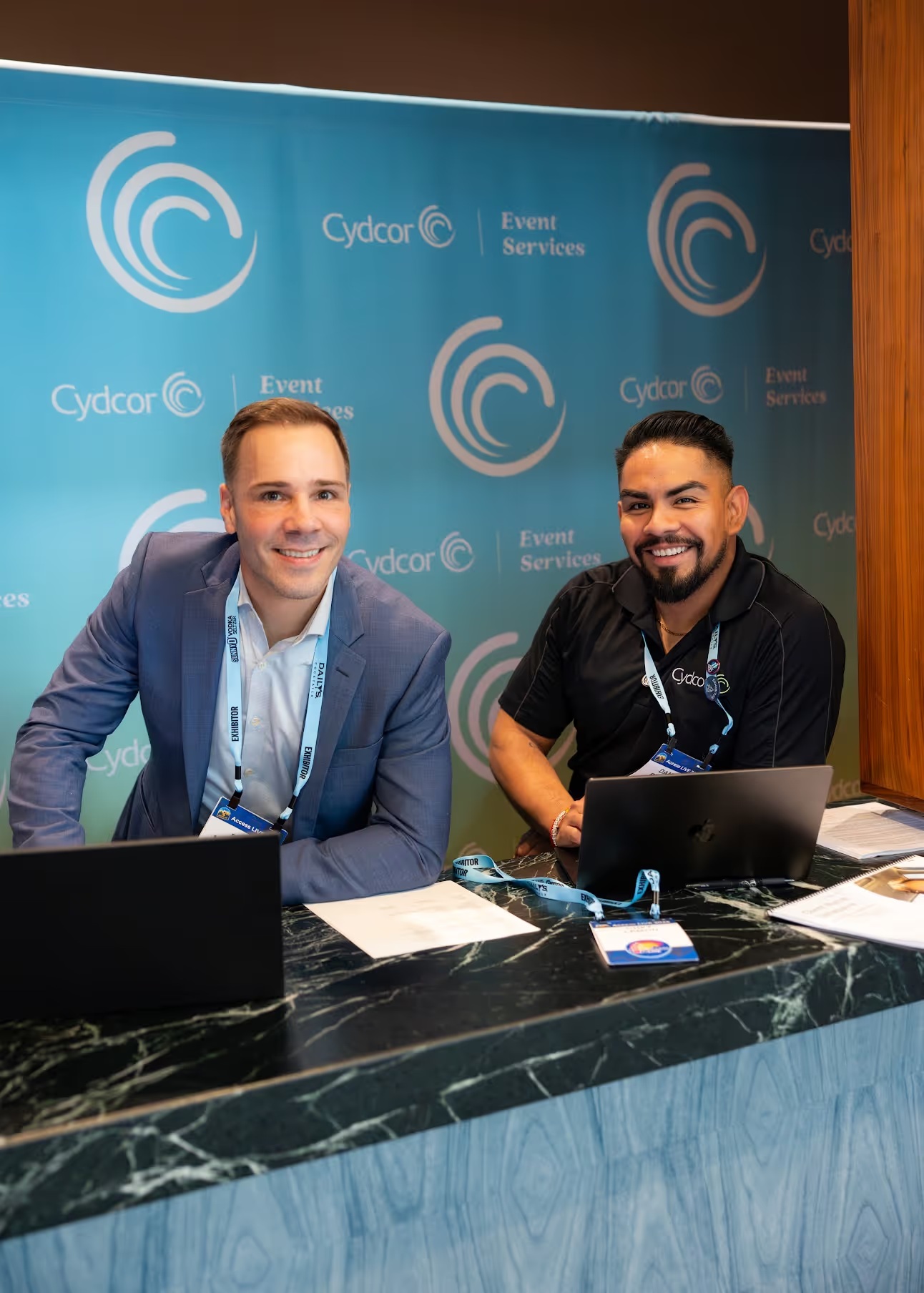 Two Cydcor Event Services representatives at an Access LIVE exhibition booth